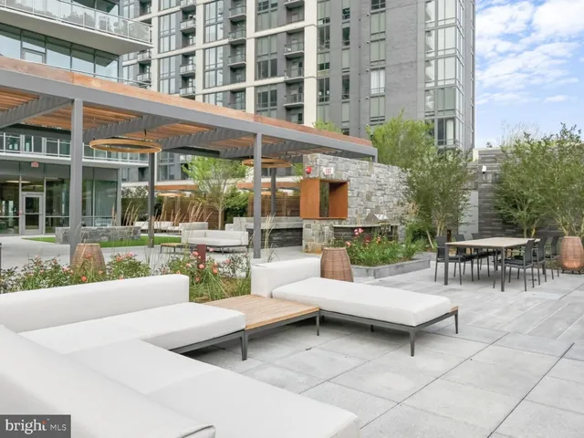 a view of a patio with couches and a table and chairs