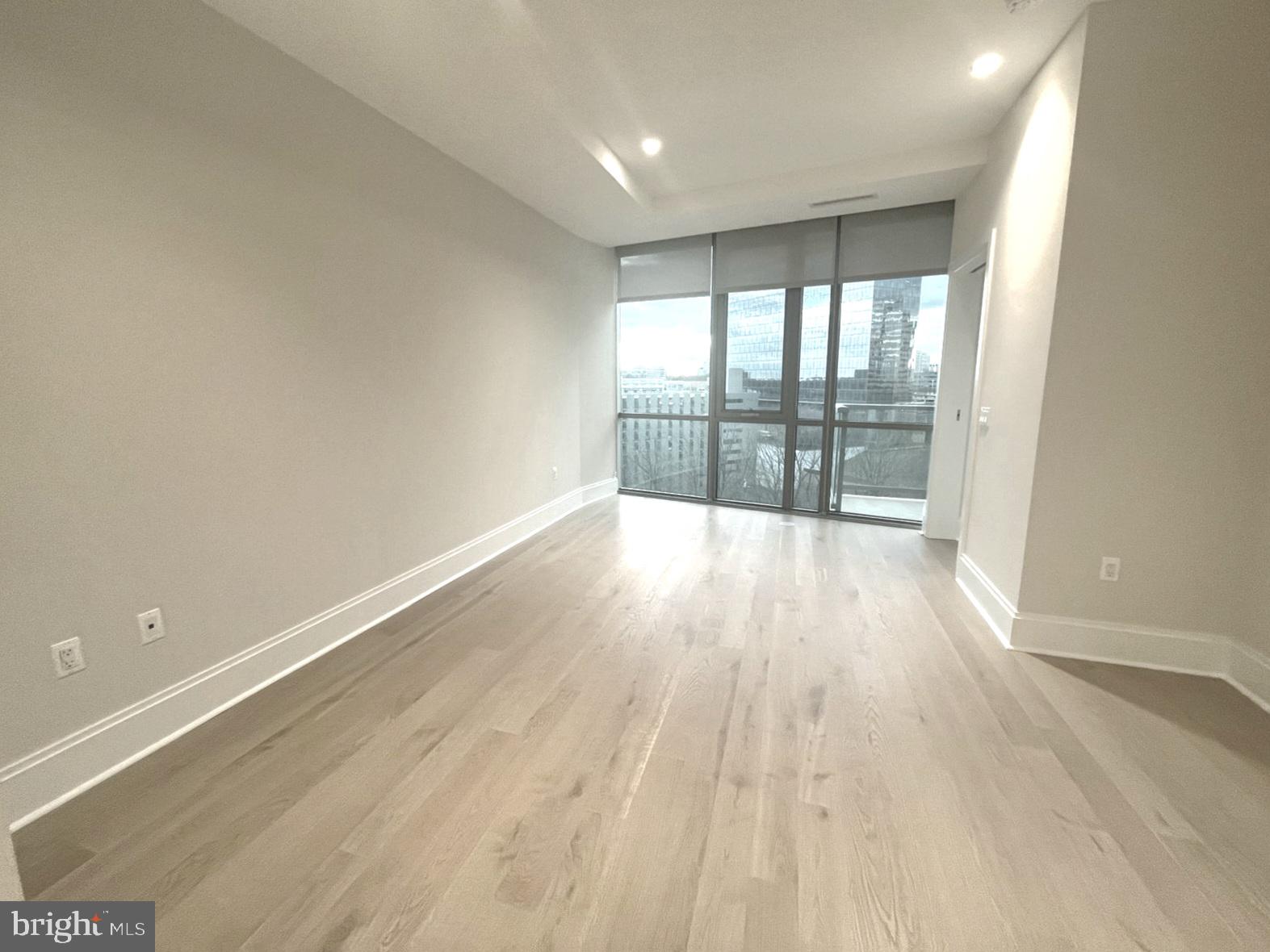 7887 Jones Branch Drive, Unit 1104 McLean, VA 22102 - Photo 7 of 42 wooden floor in an empty room with a window