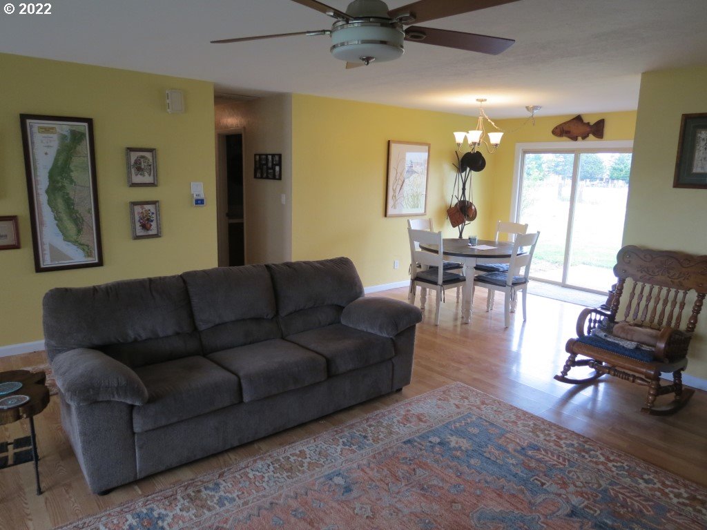 70371 Prairie Road Pendleton, OR 97801 - Photo 5 of 31 a living room with furniture and a dining table with wooden floor
