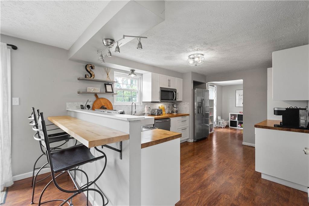 201 Arcola Drive Coraopolis, PA 15108 - Photo 13 of 33 a view of a dining room kitchen with furniture wooden floor and a sink