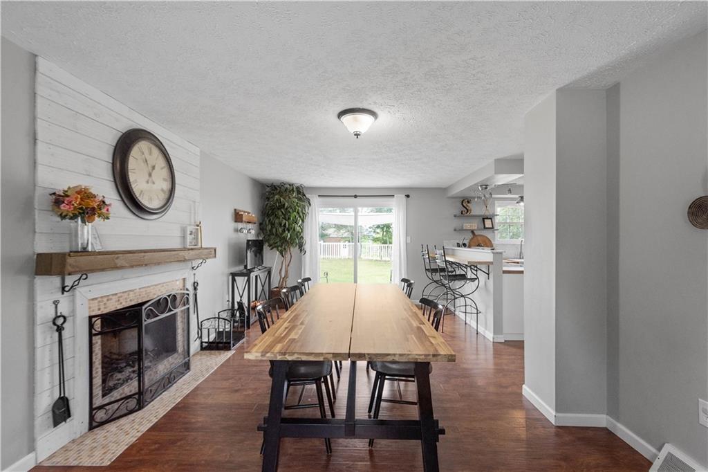 201 Arcola Drive Coraopolis, PA 15108 - Photo 15 of 33 a view of a dining room with furniture wooden floor and a fireplace