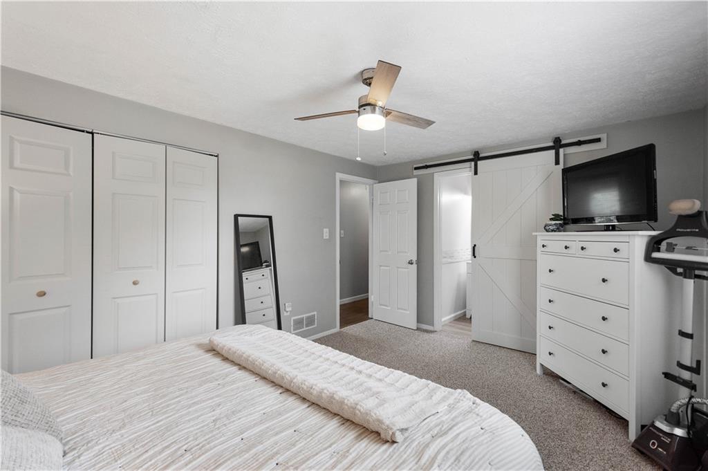 201 Arcola Drive Coraopolis, PA 15108 - Photo 19 of 33 a bedroom with a bed and a flat tv screen on dresser