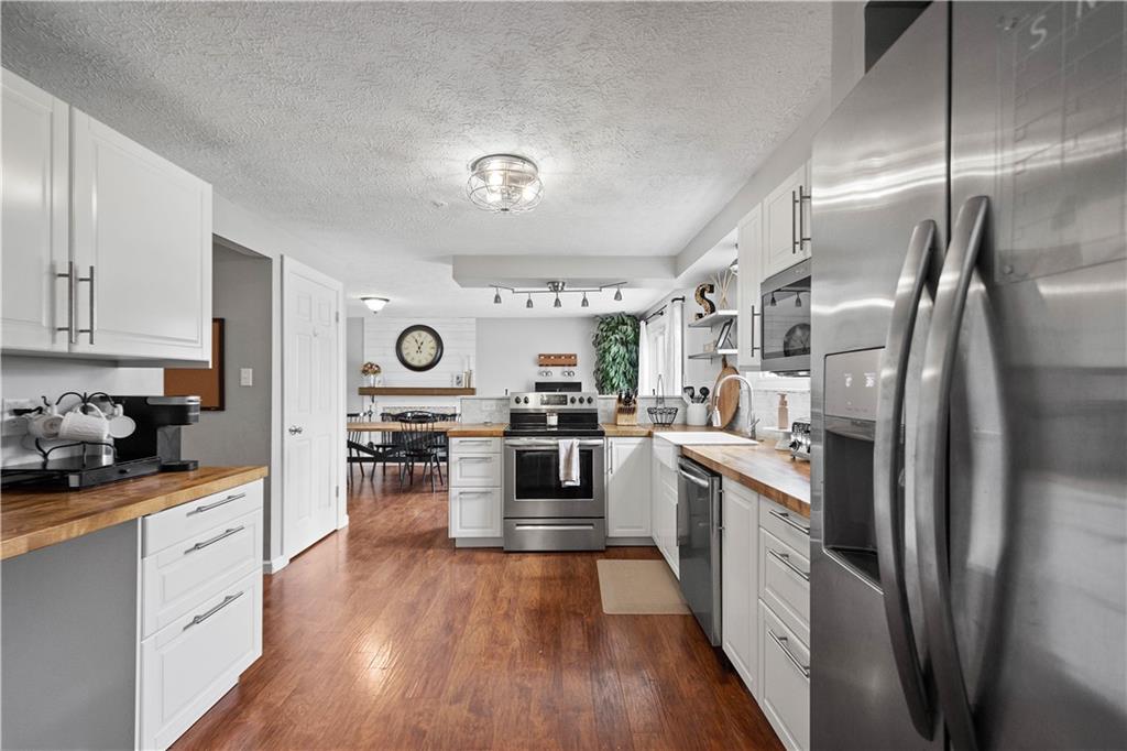 201 Arcola Drive Coraopolis, PA 15108 - Photo 9 of 33 a kitchen with stainless steel appliances granite countertop a refrigerator a stove top oven and cabinets