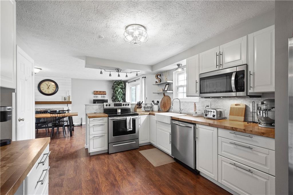 201 Arcola Drive Coraopolis, PA 15108 - Photo 10 of 33 a kitchen with granite countertop stainless steel appliances and wooden floor