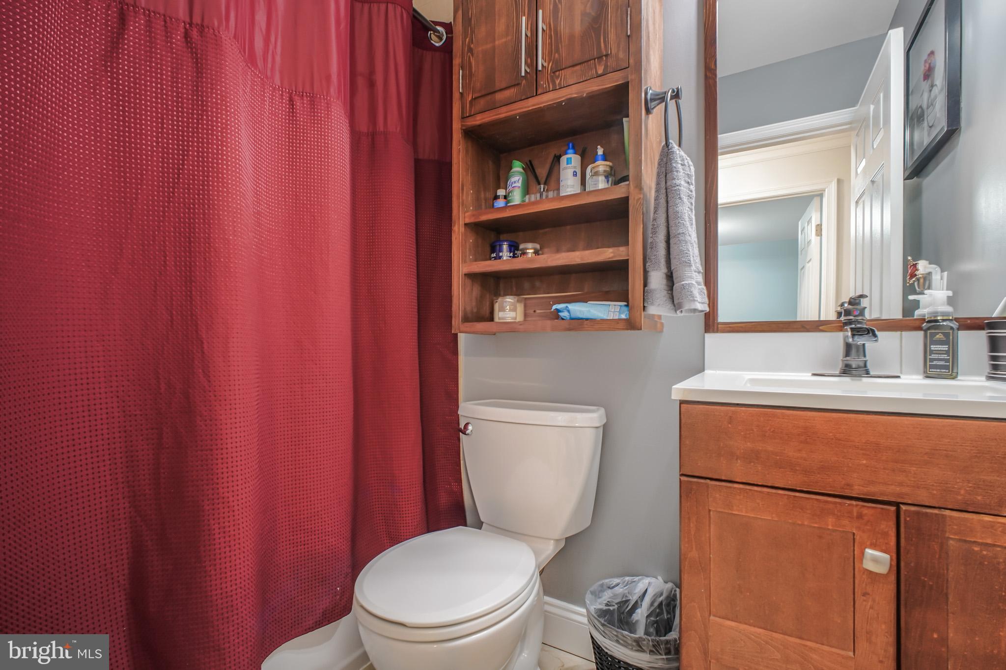 8227 Frye Road Alexandria, VA 22309 - Photo 27 of 45 a bathroom with a toilet a sink and a shower curtain