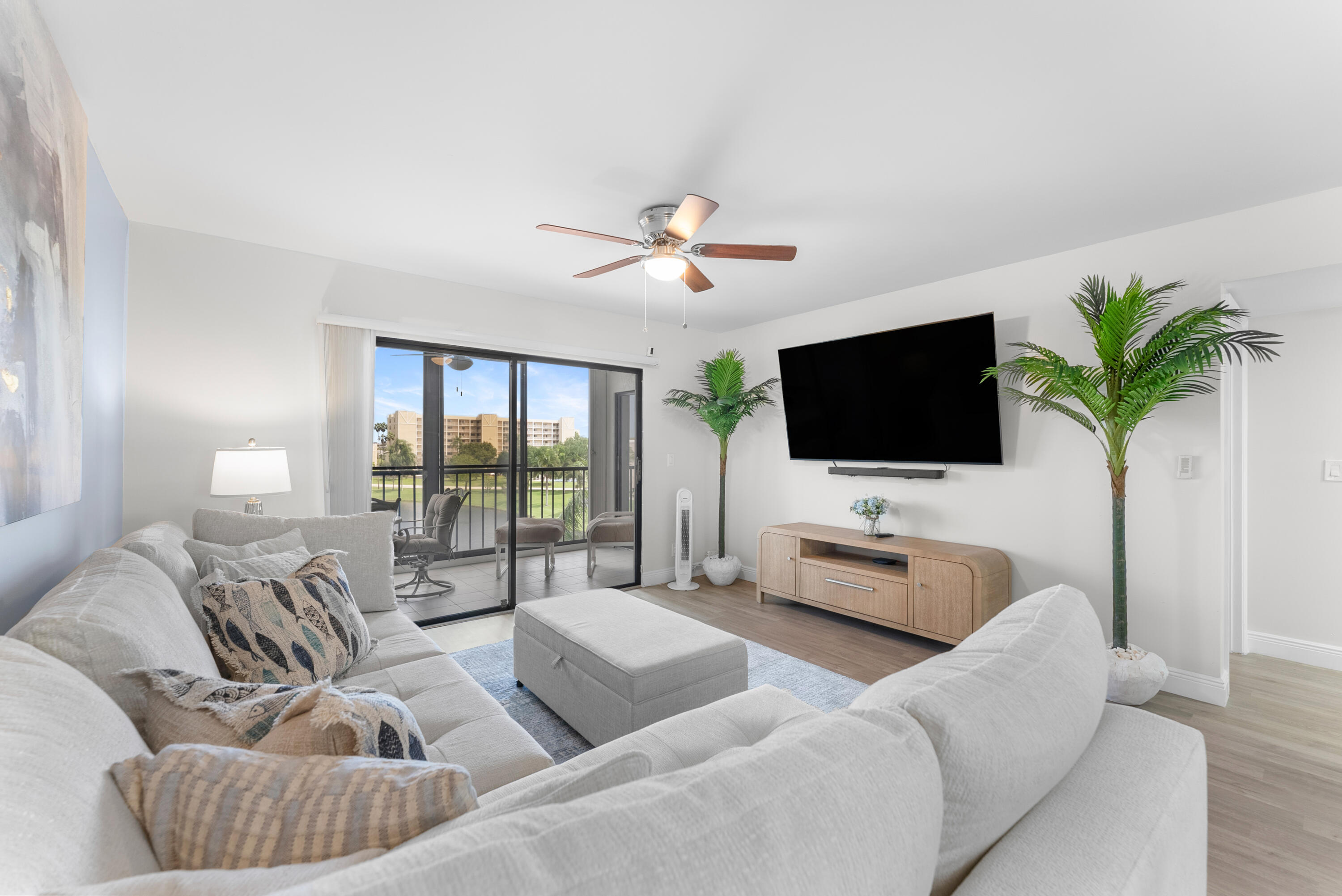 14500 Stirling Way, Unit 403 Delray Beach, FL 33446 - Photo 14 of 47 a living room with furniture and a flat screen tv