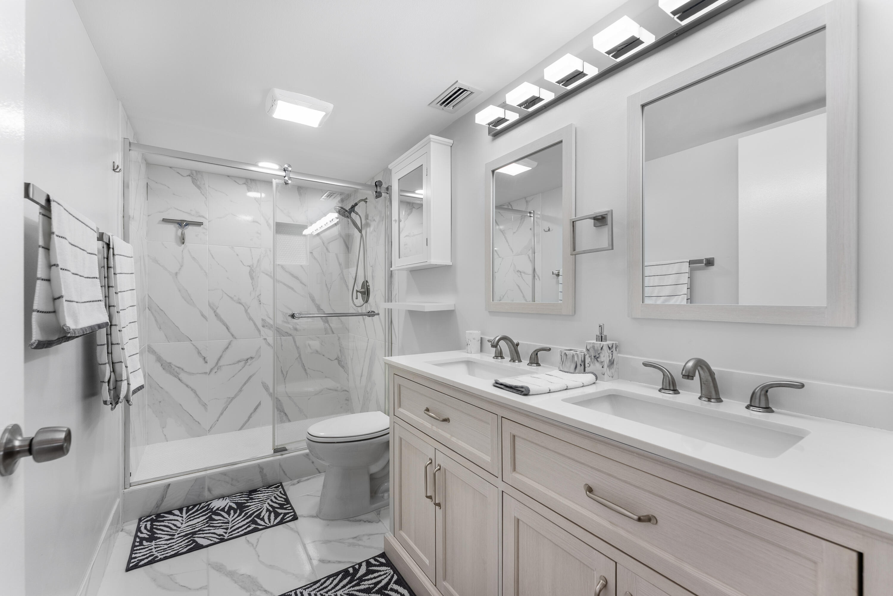 14500 Stirling Way, Unit 403 Delray Beach, FL 33446 - Photo 22 of 47 a bathroom with a double vanity sink mirror double and a shower