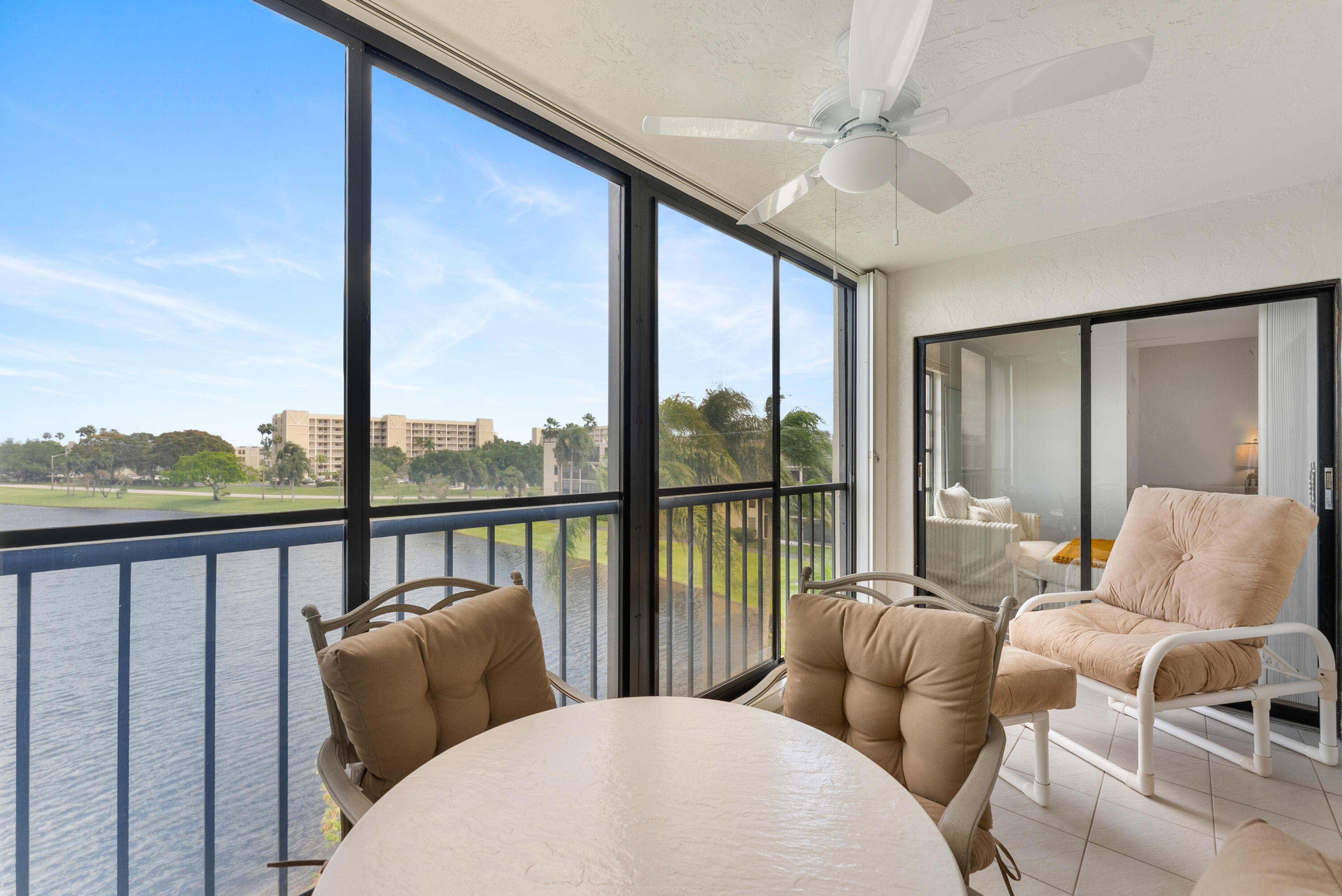 14500 Stirling Way, Unit 403 Delray Beach, FL 33446 - Photo 26 of 47 a living room with furniture a large window and a chandelier