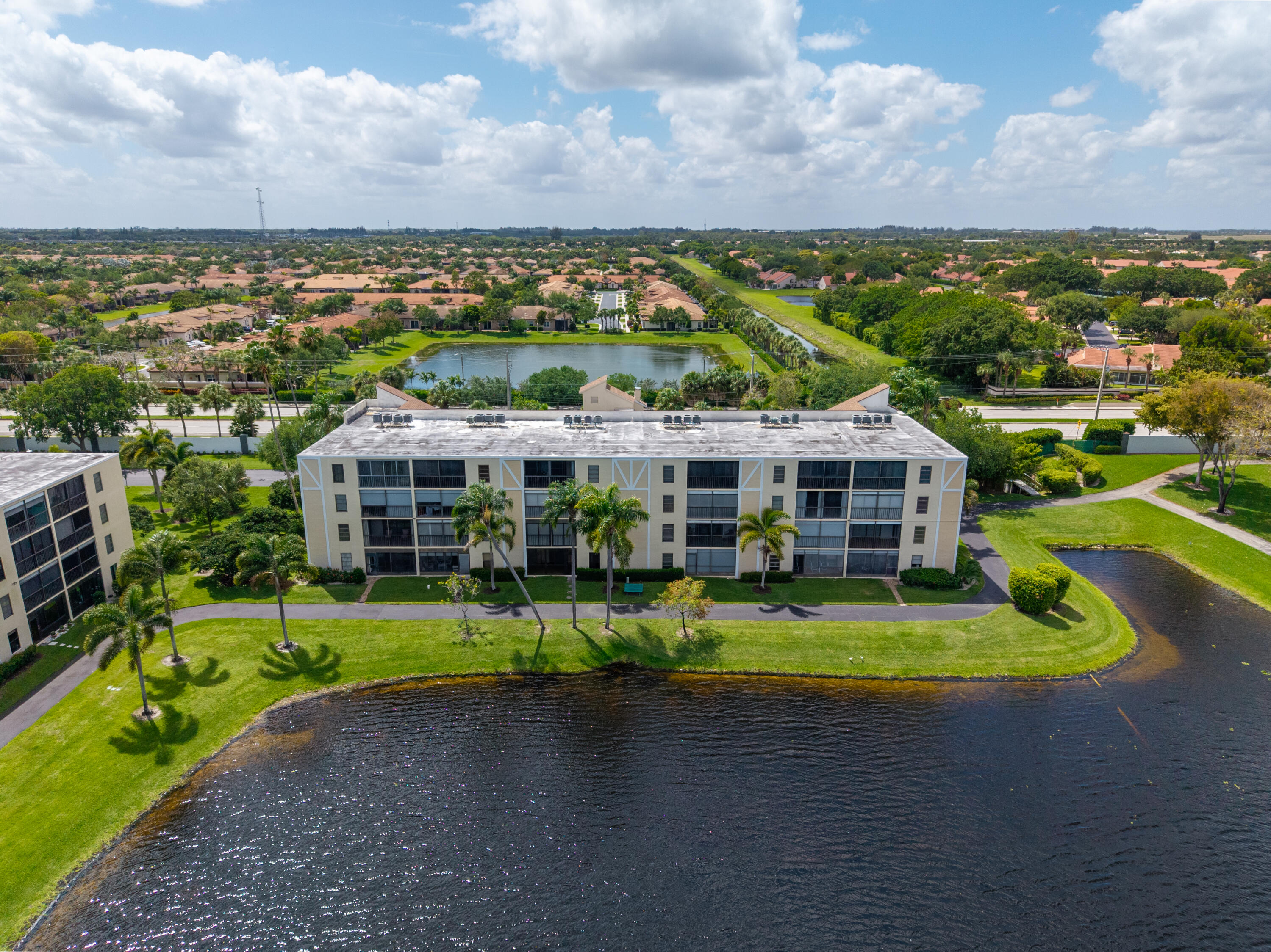 14500 Stirling Way, Unit 403 Delray Beach, FL 33446 - Photo 34 of 47 a view of a city with lawn chairs and large trees
