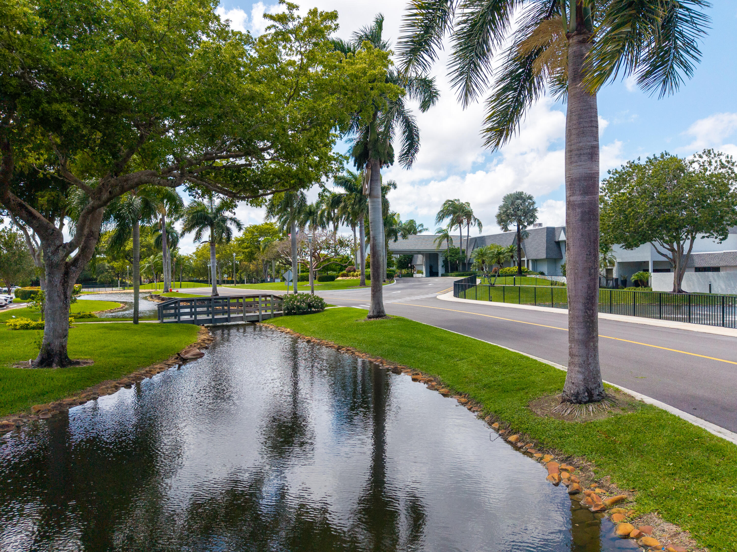 14500 Stirling Way, Unit 403 Delray Beach, FL 33446 - Photo 42 of 47 a view of a park with trees and a lake