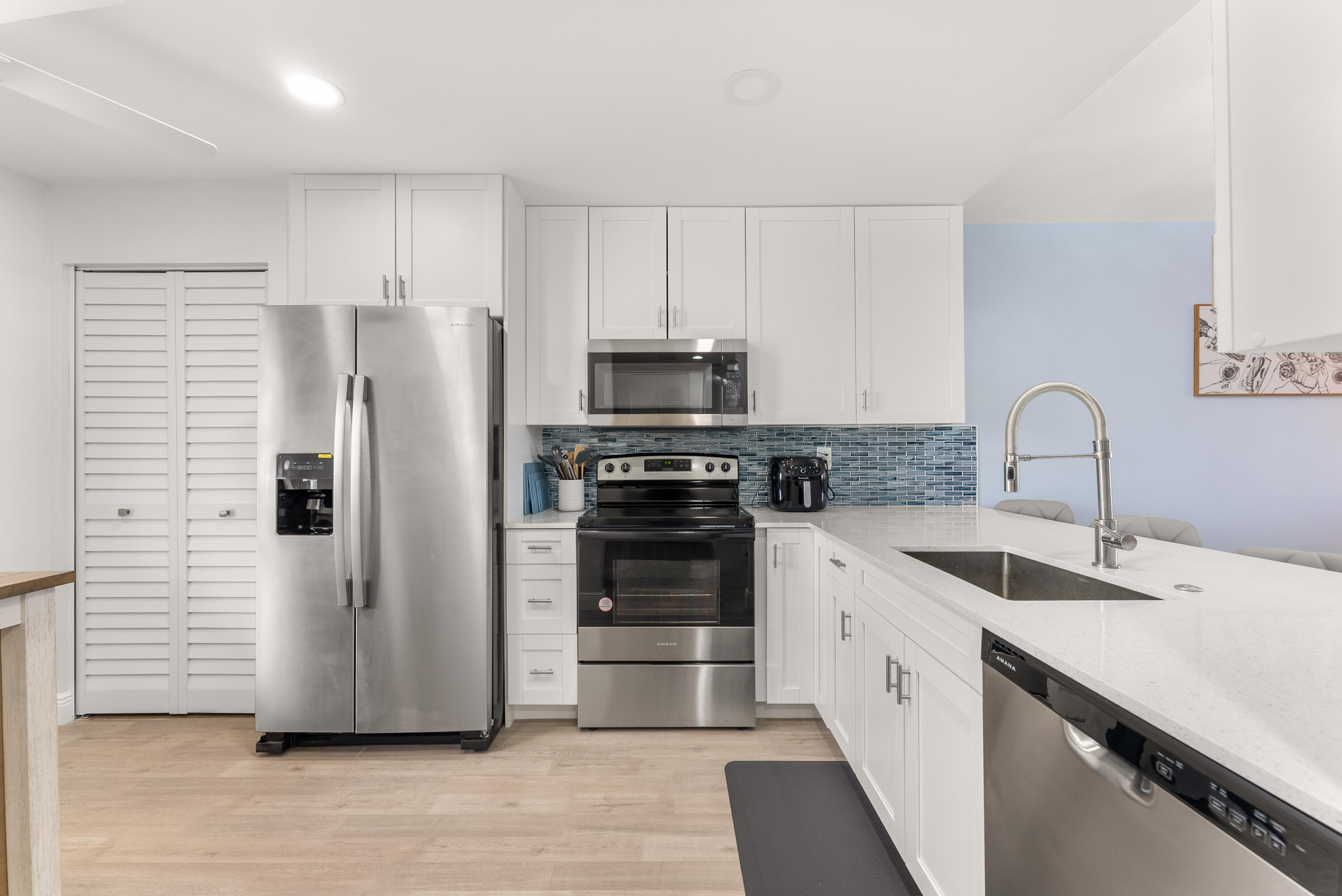 14500 Stirling Way, Unit 403 Delray Beach, FL 33446 - Photo 6 of 47 a kitchen with a sink cabinets and stainless steel appliances