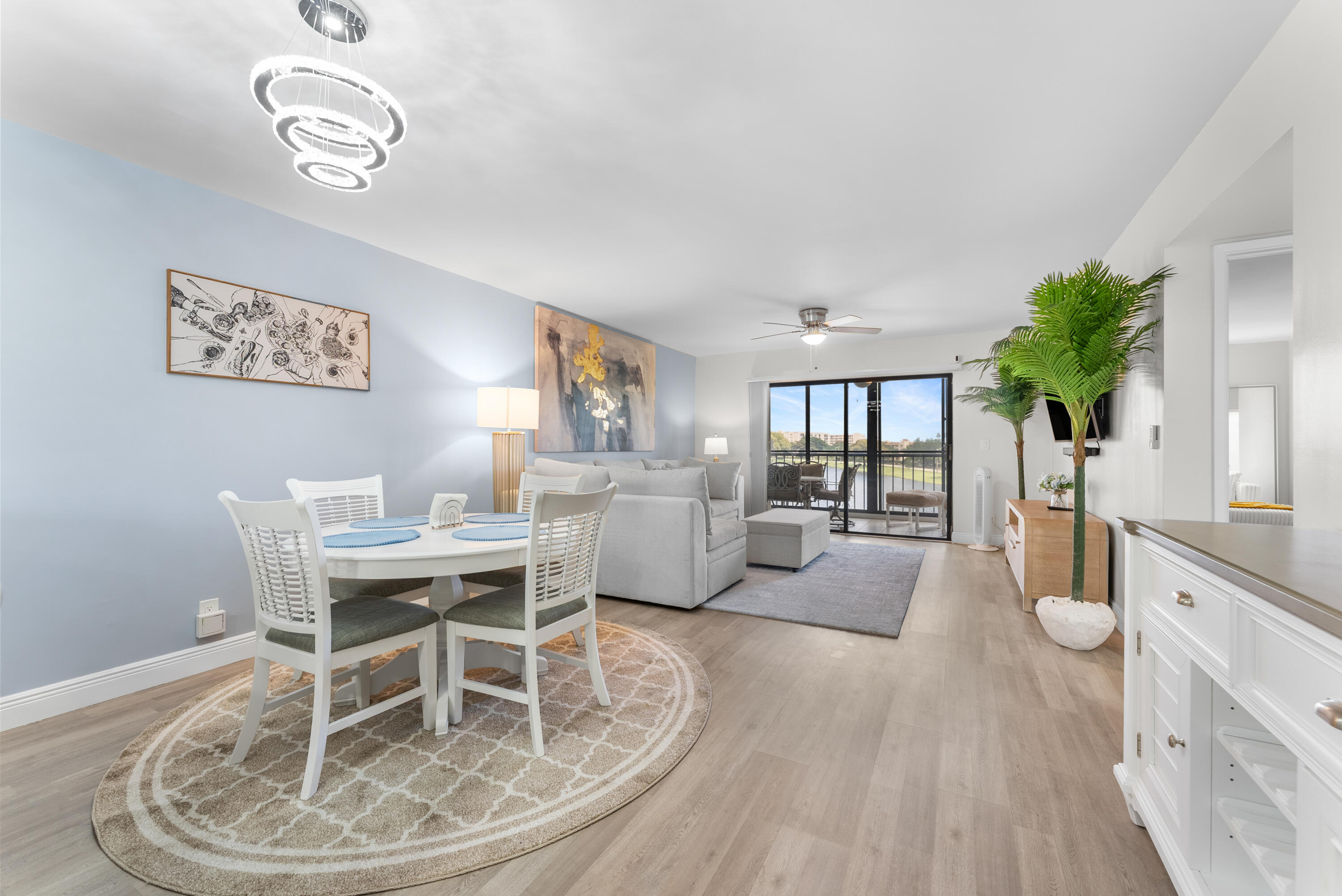 14500 Stirling Way, Unit 403 Delray Beach, FL 33446 - Photo 10 of 47 a living room with furniture a chandelier and a dining table