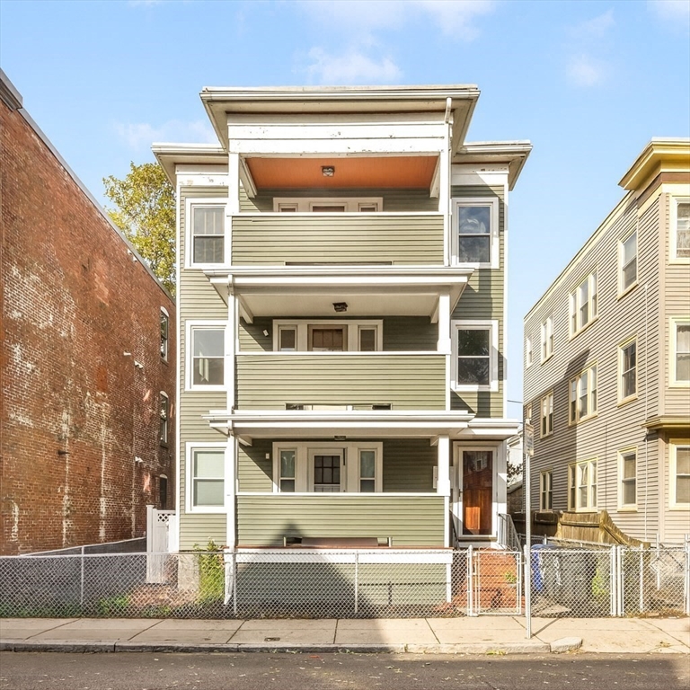 a front view of a building with a garden