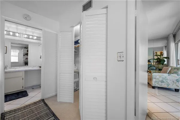 a bathroom with a granite countertop sink a toilet a mirror and shower