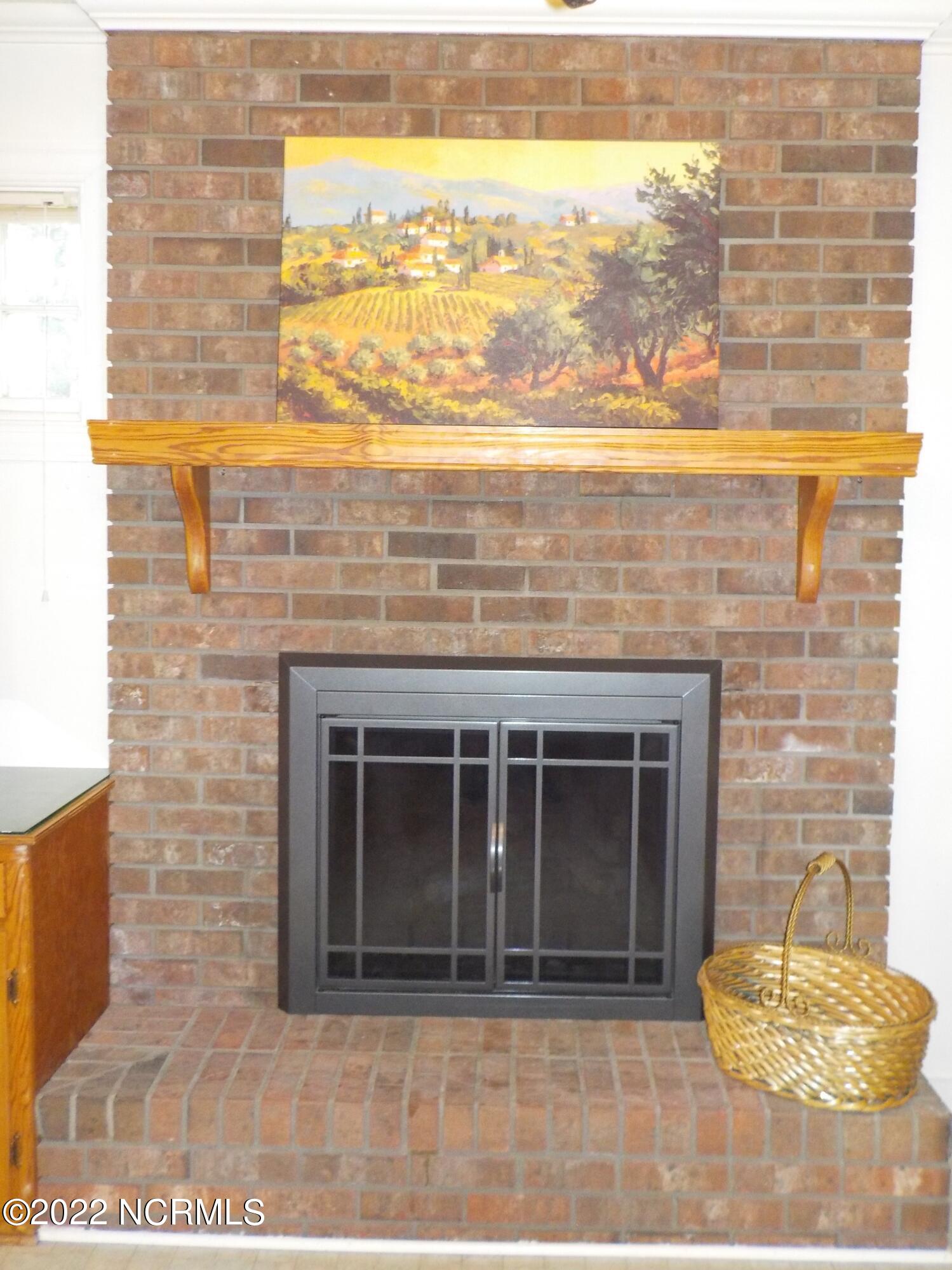 10856 Straight Gate Road Whitakers, NC 27891 - Photo 20 of 41 masonry fireplace with gas logs