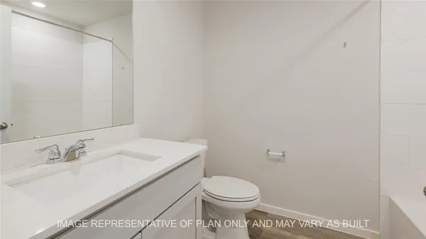 a bathroom with a sink a toilet and vanity