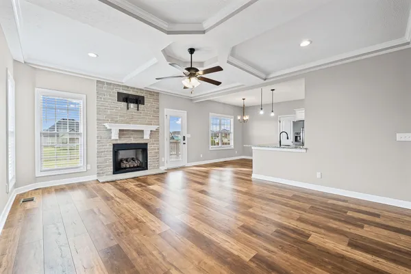 a view of an empty room with a fireplace and a window