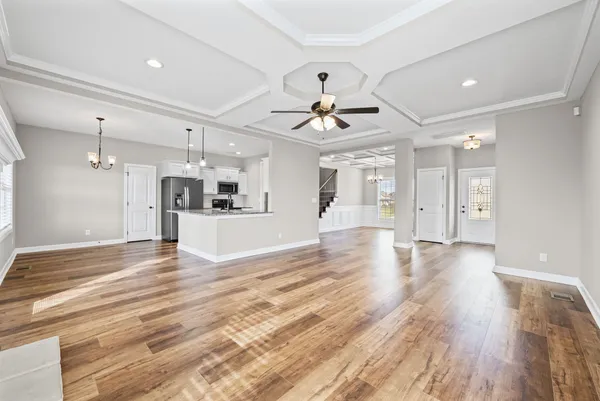 a view of a kitchen with a sink and a refrigerator