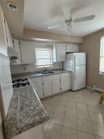 a kitchen with a stove a sink and a refrigerator