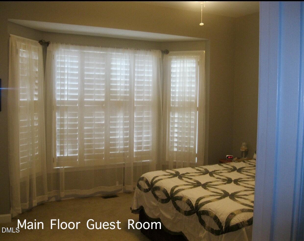 12400 Village Gate Way Raleigh, NC 27614 - Photo 16 of 34 a bed sitting in a bedroom next to a window