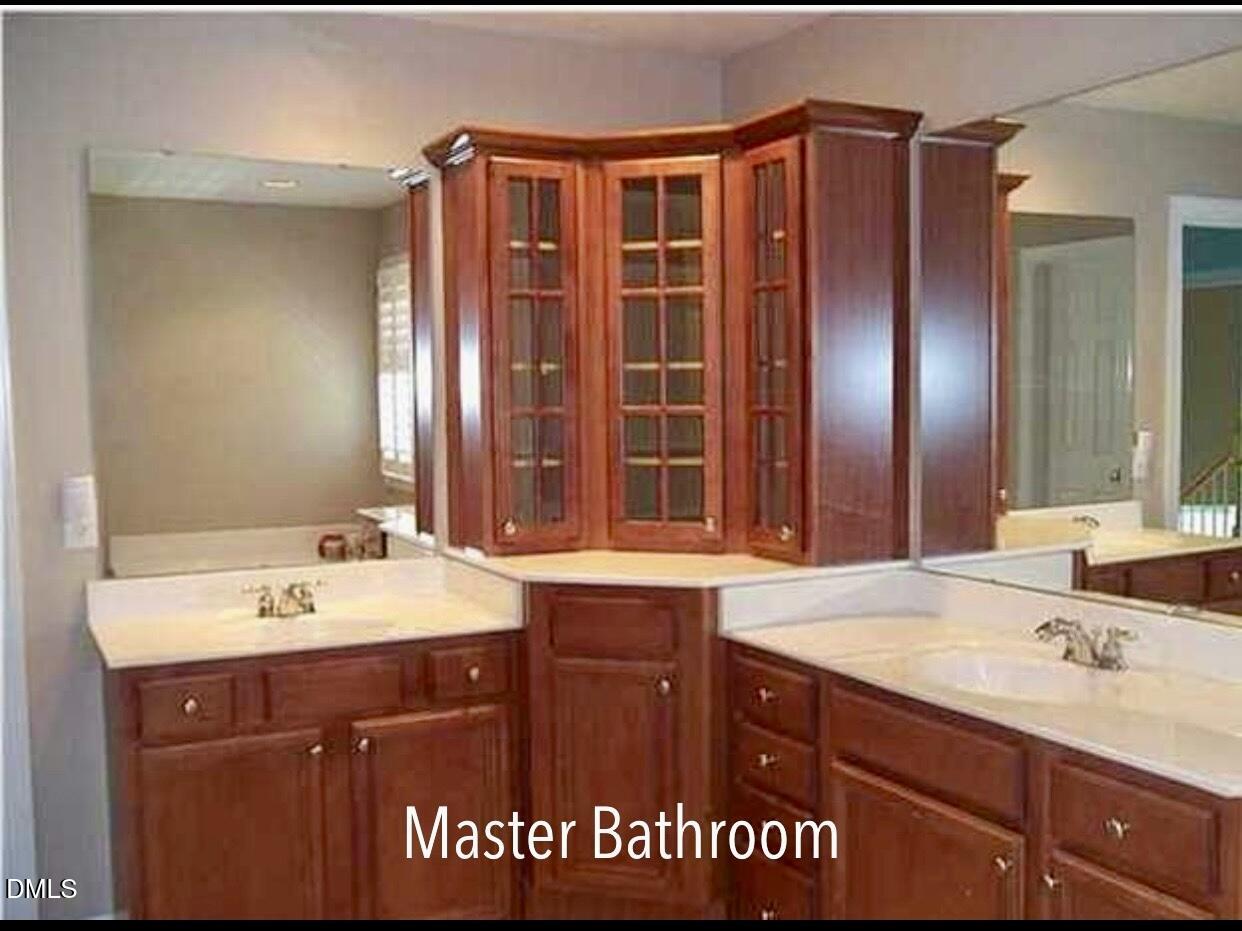 12400 Village Gate Way Raleigh, NC 27614 - Photo 23 of 34 a bathroom with a sink double vanity and a mirror