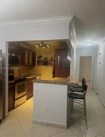 a kitchen with a stove and a refrigerator