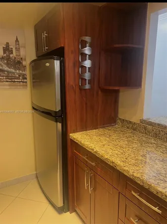 a kitchen with a refrigerator and cabinets