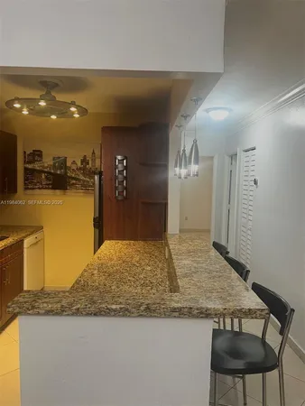 a kitchen with stainless steel appliances granite countertop a sink and a refrigerator