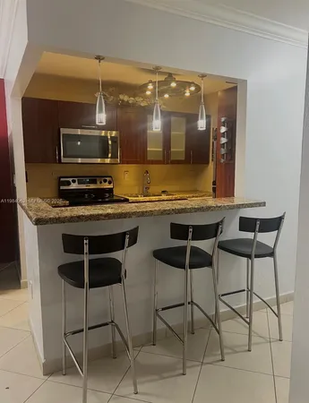 a kitchen with a stove a sink and a microwave