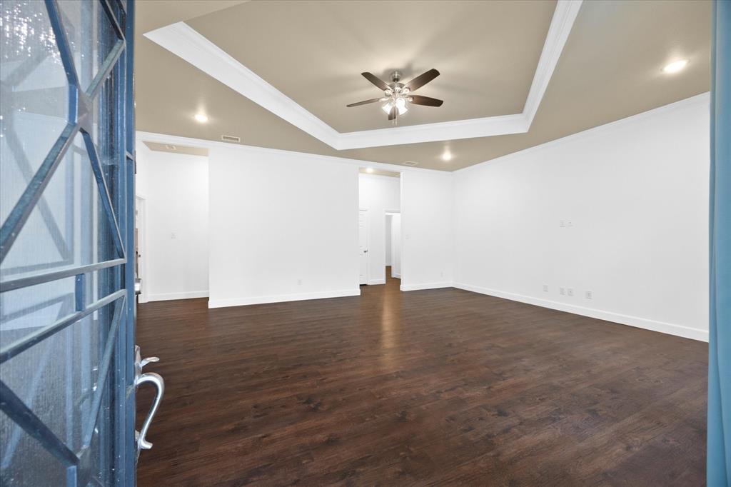 2526 Fox Point Circle Quinlan, TX 75474 - Photo 9 of 35 Expansive family room includes tiered ceiling and wood floors