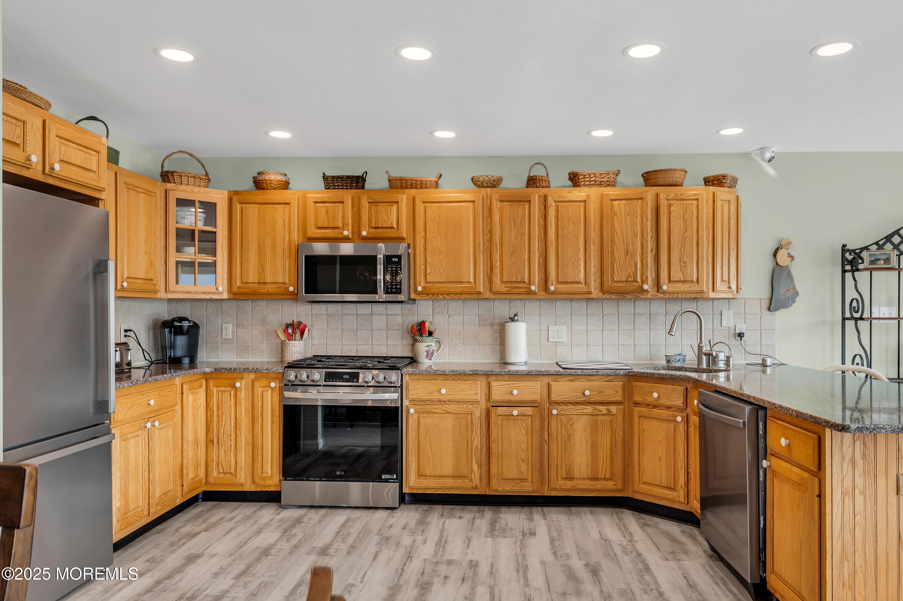 837 Forepeak Drive Forked River, NJ 08731 - Photo 39 of 55 a kitchen with stainless steel appliances granite countertop a stove a sink and a refrigerator