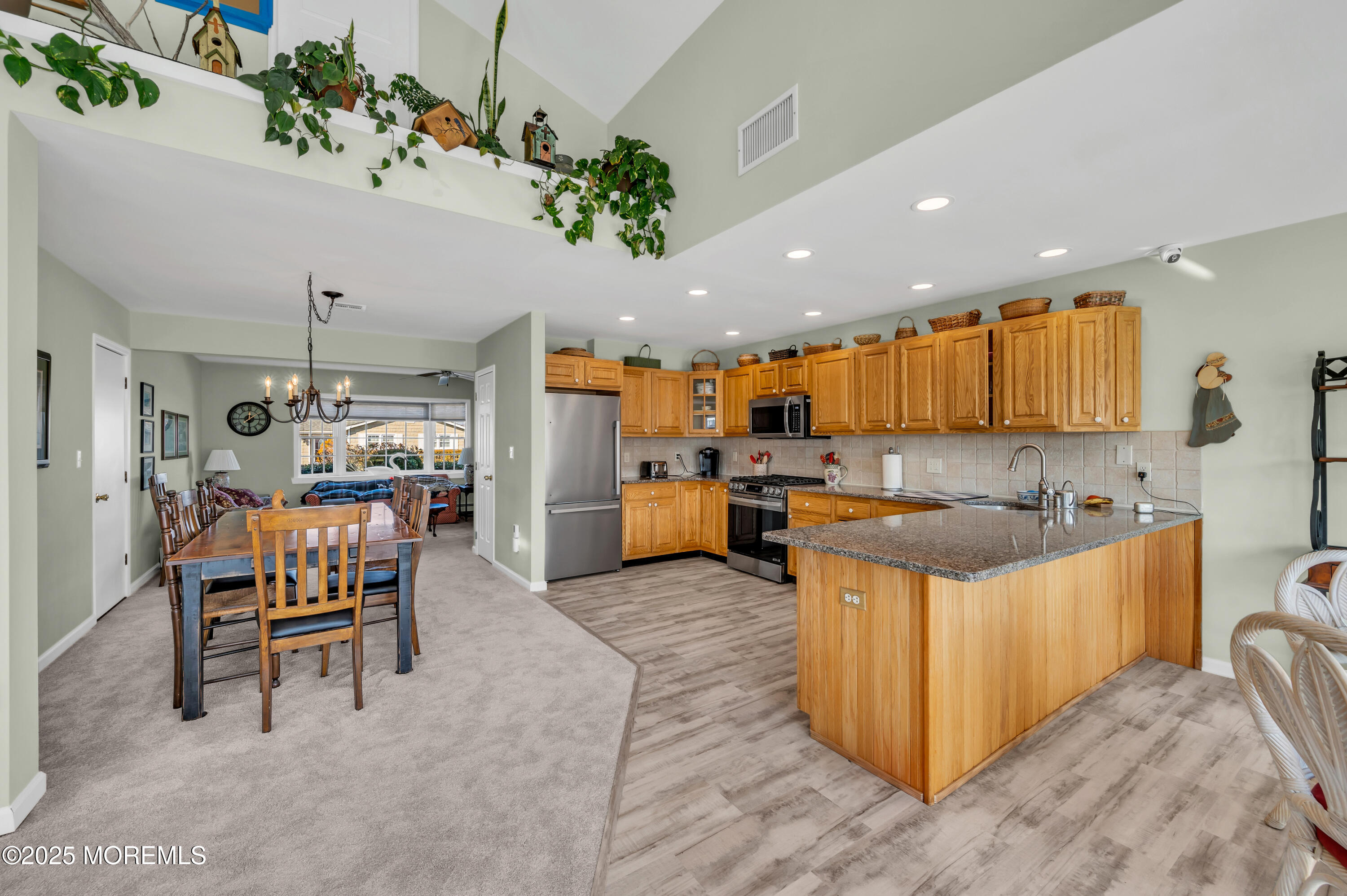 837 Forepeak Drive Forked River, NJ 08731 - Photo 40 of 55 a kitchen with kitchen island a stove a table and chairs in it