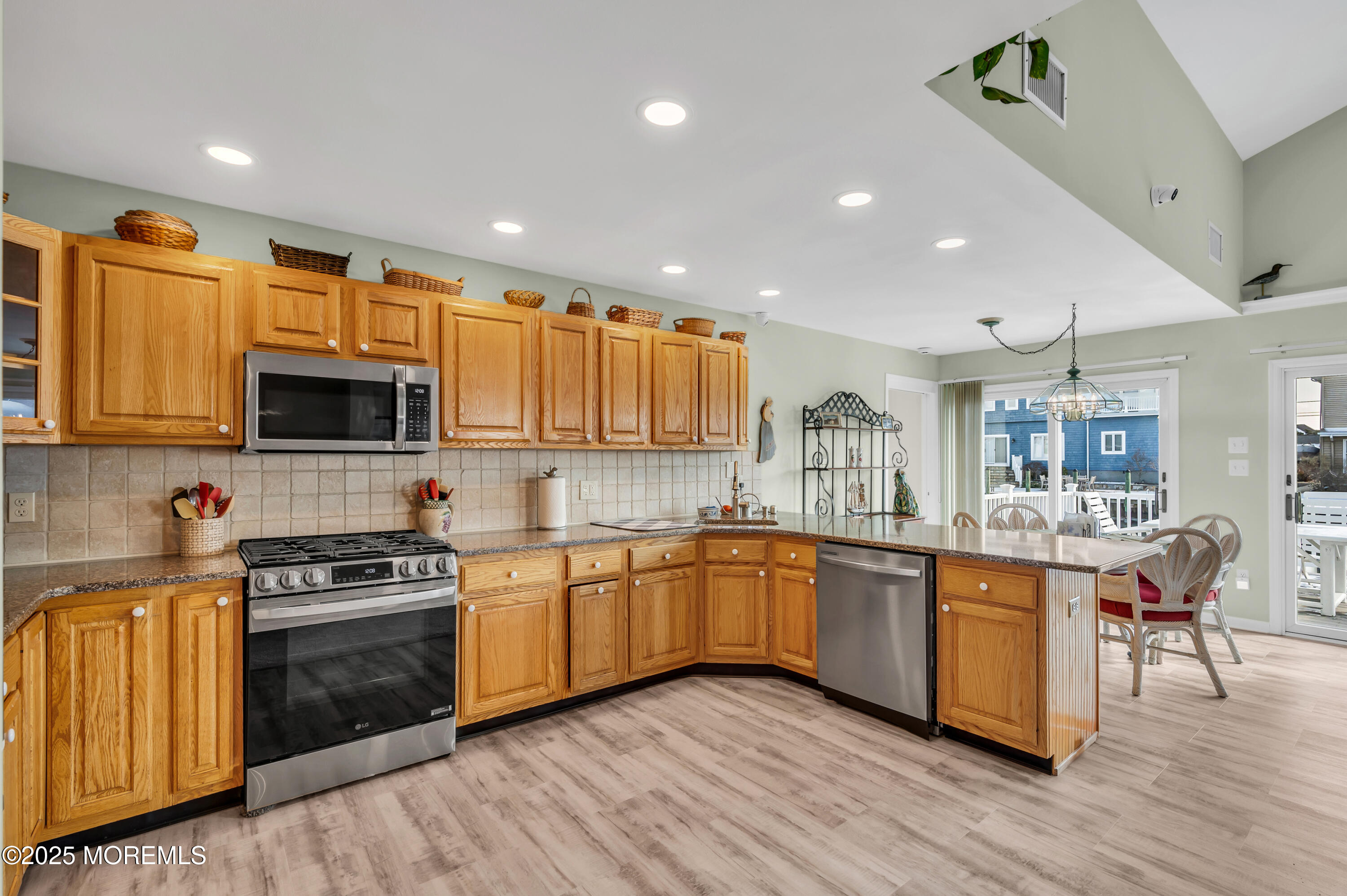 837 Forepeak Drive Forked River, NJ 08731 - Photo 45 of 55 a kitchen with stainless steel appliances granite countertop wooden cabinets a sink dishwasher a stove and a refrigerator with wooden floor