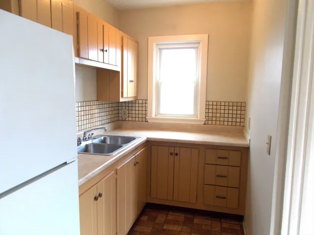 a kitchen with granite countertop a sink and a window