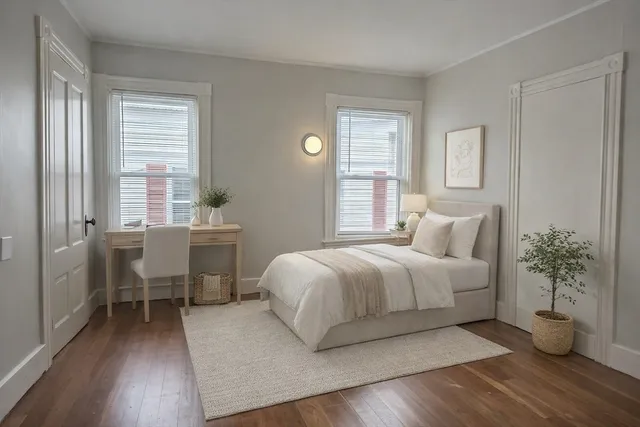 a bedroom with a large bed and a chandelier