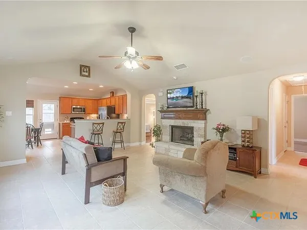 a living room with furniture fireplace and a chandelier
