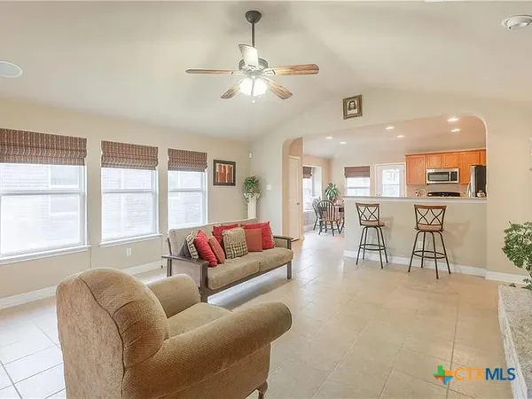 a living room with furniture and a large window