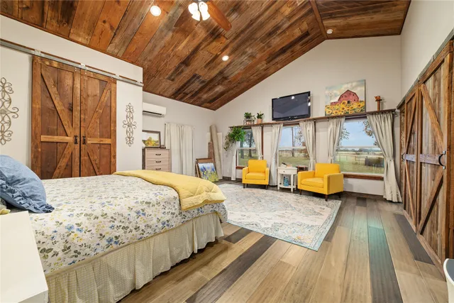 a bedroom with bed couch and a window