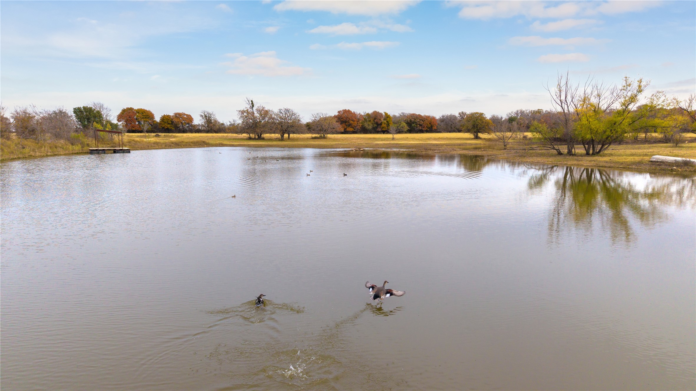355 County Road 144 Comanche, TX 76442 - Photo 5 of 14 a view of a lake with houses in the back