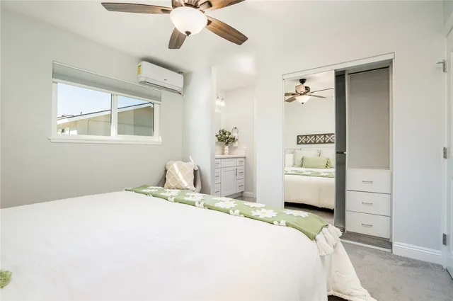 a bedroom with a large bed and a chandelier