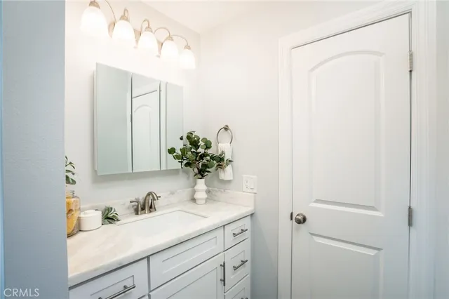 a bathroom with a sink a vanity and a mirror