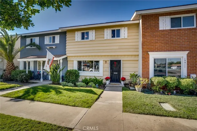 a front view of a house with a yard and porch