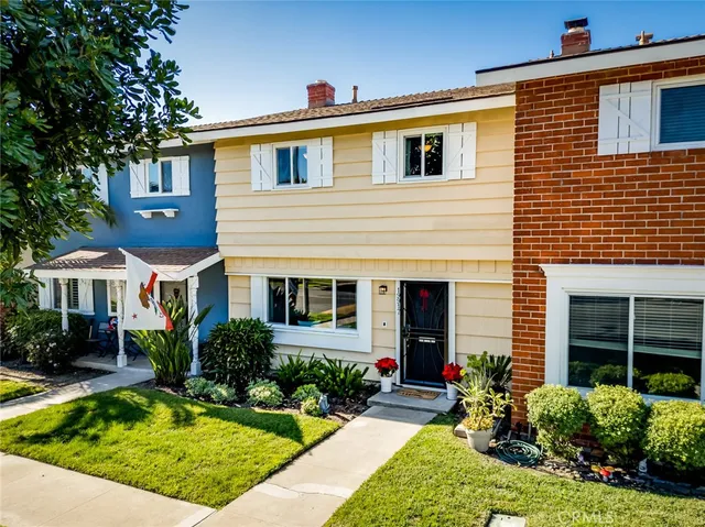 a front view of a house with yard and green space