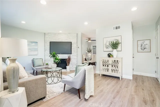 a living room with furniture and wooden floor