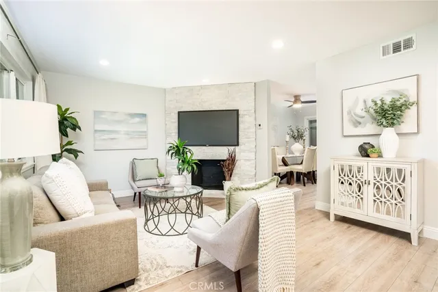 a living room with furniture a fireplace and a flat screen tv