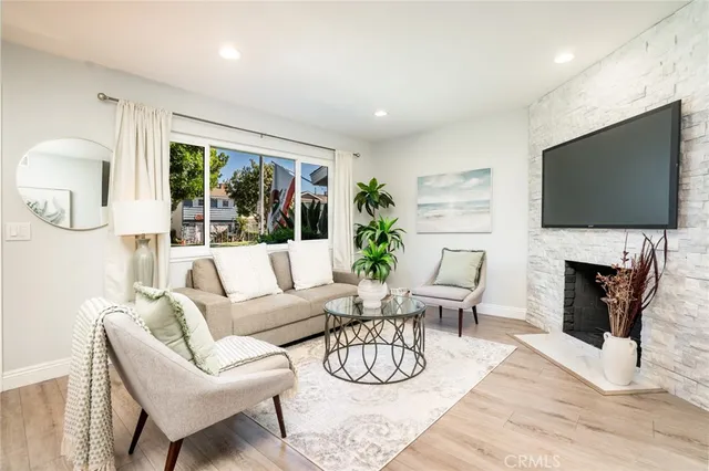 a living room with fireplace furniture and a flat screen tv