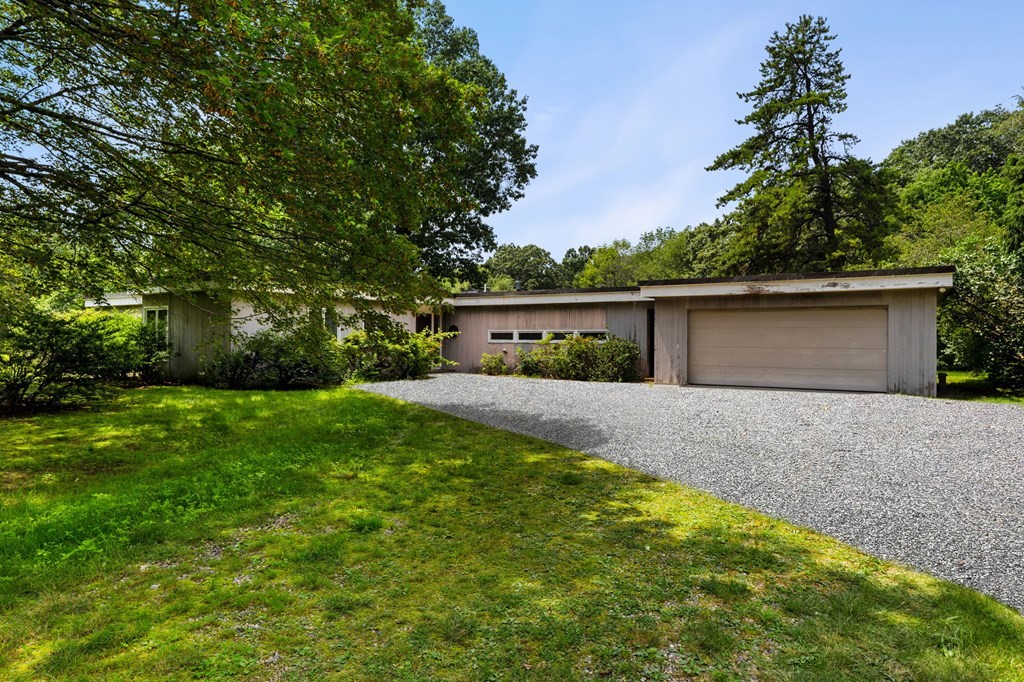 91 Weston Road Lincoln, MA 01773 - Photo 1 of 34 a view of a house with a yard and a garage