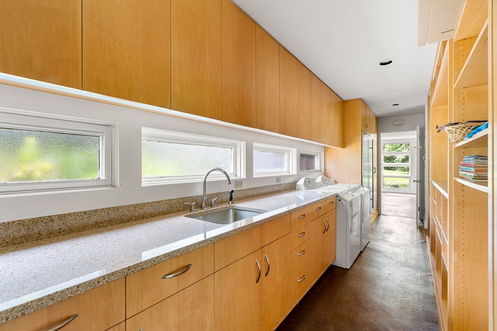 91 Weston Road Lincoln, MA 01773 - Photo 11 of 34 a kitchen with stainless steel appliances a sink a stove and a window