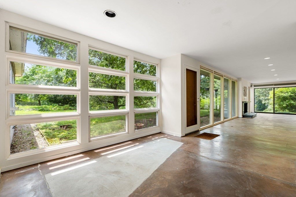 91 Weston Road Lincoln, MA 01773 - Photo 16 of 34 a view of an empty room with wooden floor and a window