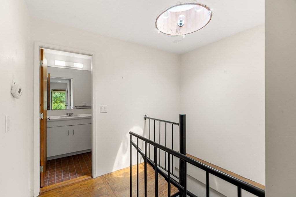 91 Weston Road Lincoln, MA 01773 - Photo 22 of 34 a view of a hallway and a livingroom with wooden floor